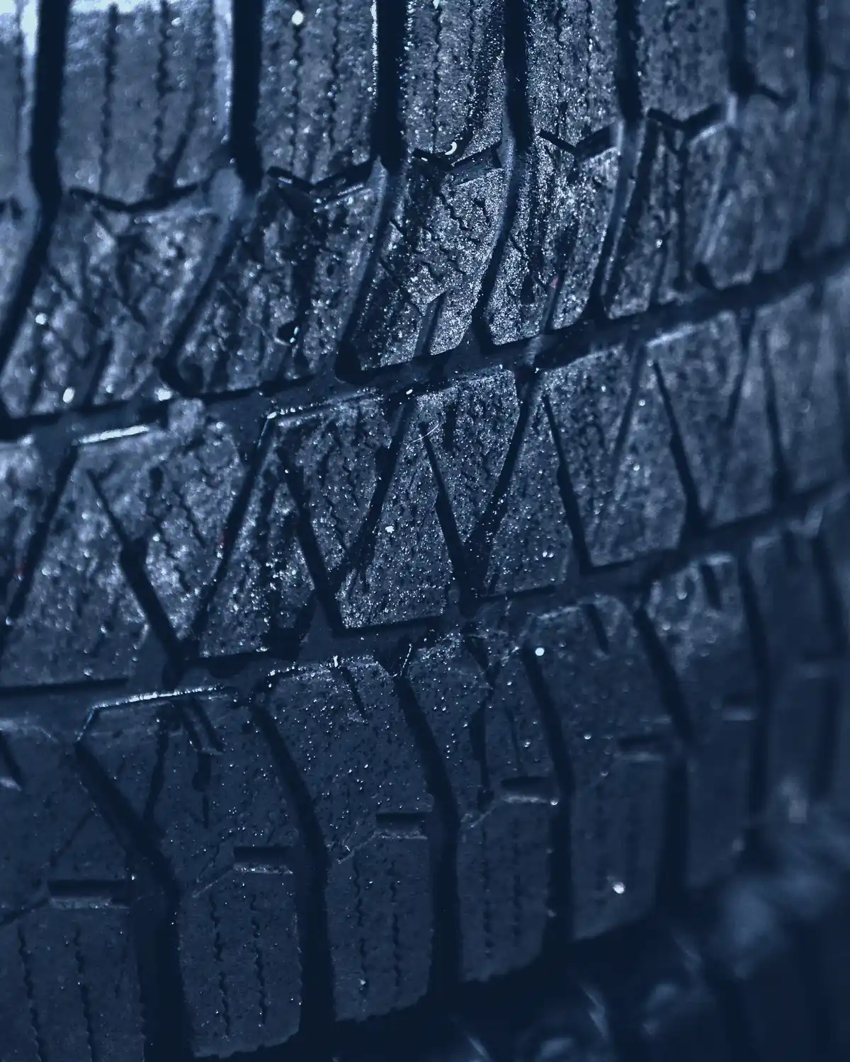 Close-up of chunky tyre tread blocks in low light